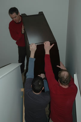 Carrying a dresser downstairs on moving day