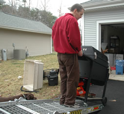 A grill being prepared for loading into the trailer