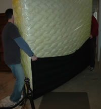 Carrying a mattress out to the trailer