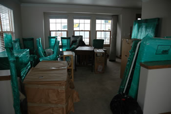 The house mid-unload, full of boxes and furniture