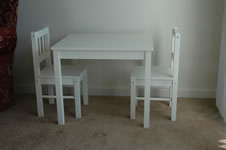 A table and chairs wrapped and staged for loading