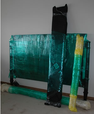 Furniture wrapped in moving blankets before loading