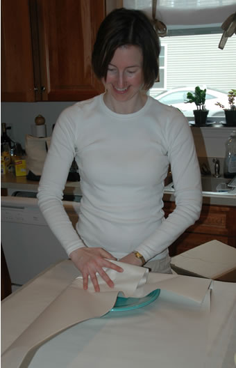 Dishes being wrapped in packing paper before boxing